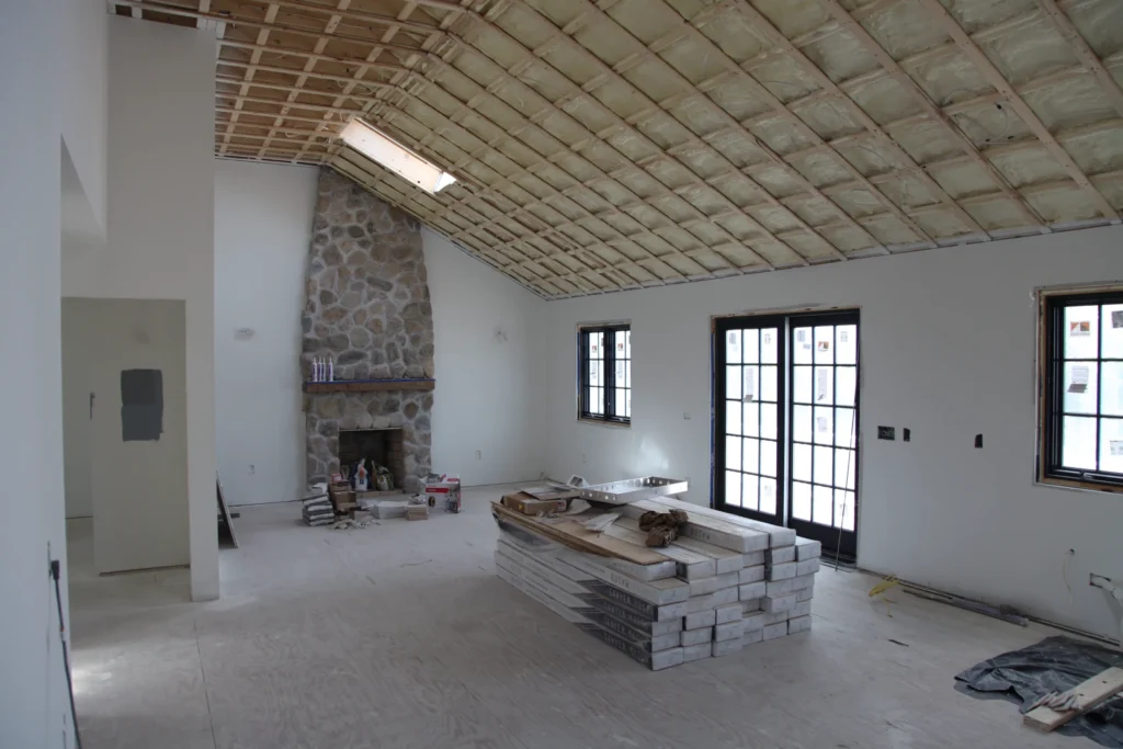 Stone fireplace and building materials inside a vaulted Dennis, MA home renovation