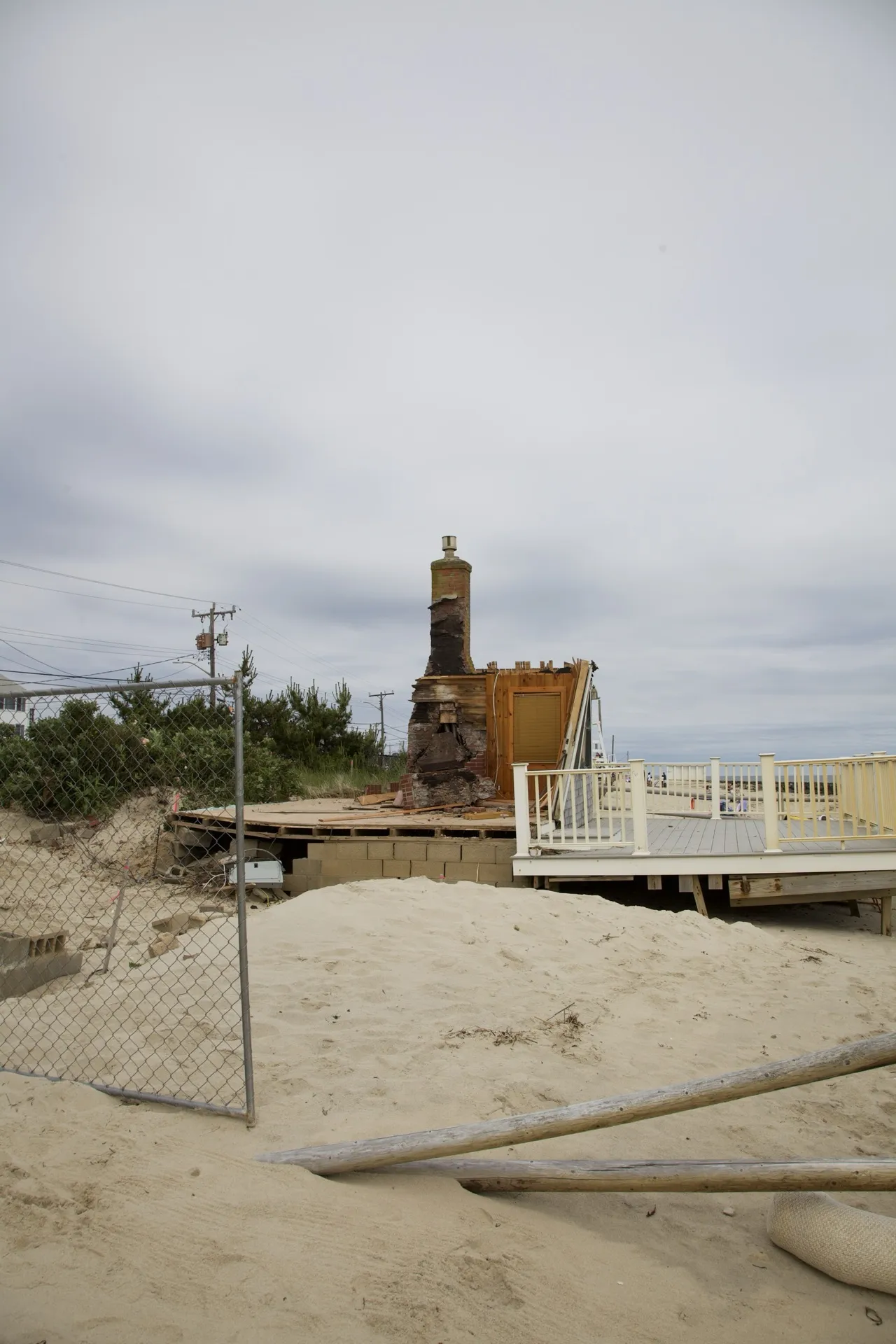 Cleared Dennis Port beachfront lot with only the chimney stump remaining, ready for new construction.