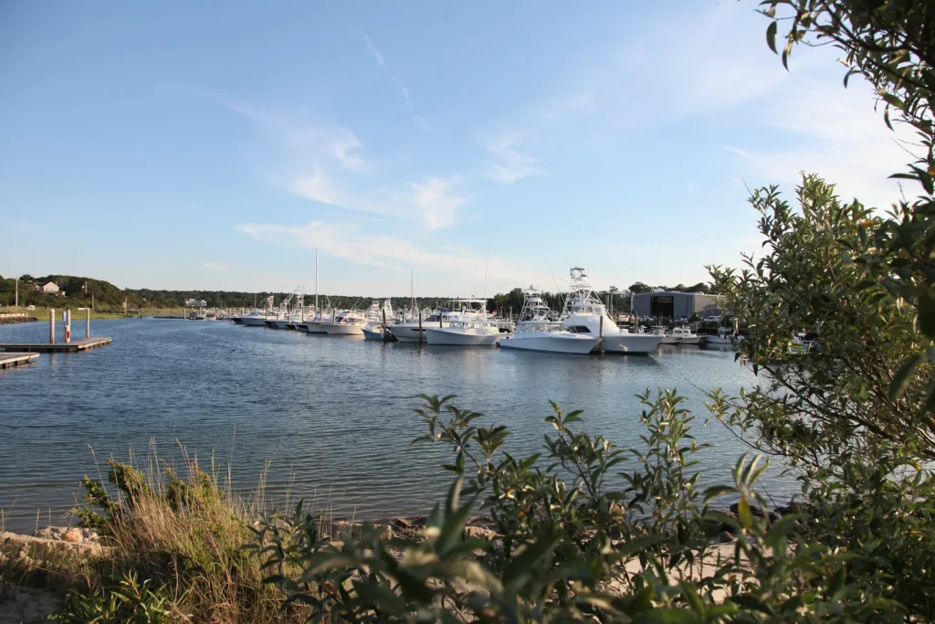 Boats moored at Sesuit Harbor in East Dennis, Massachusetts on a clear summer afternoon.