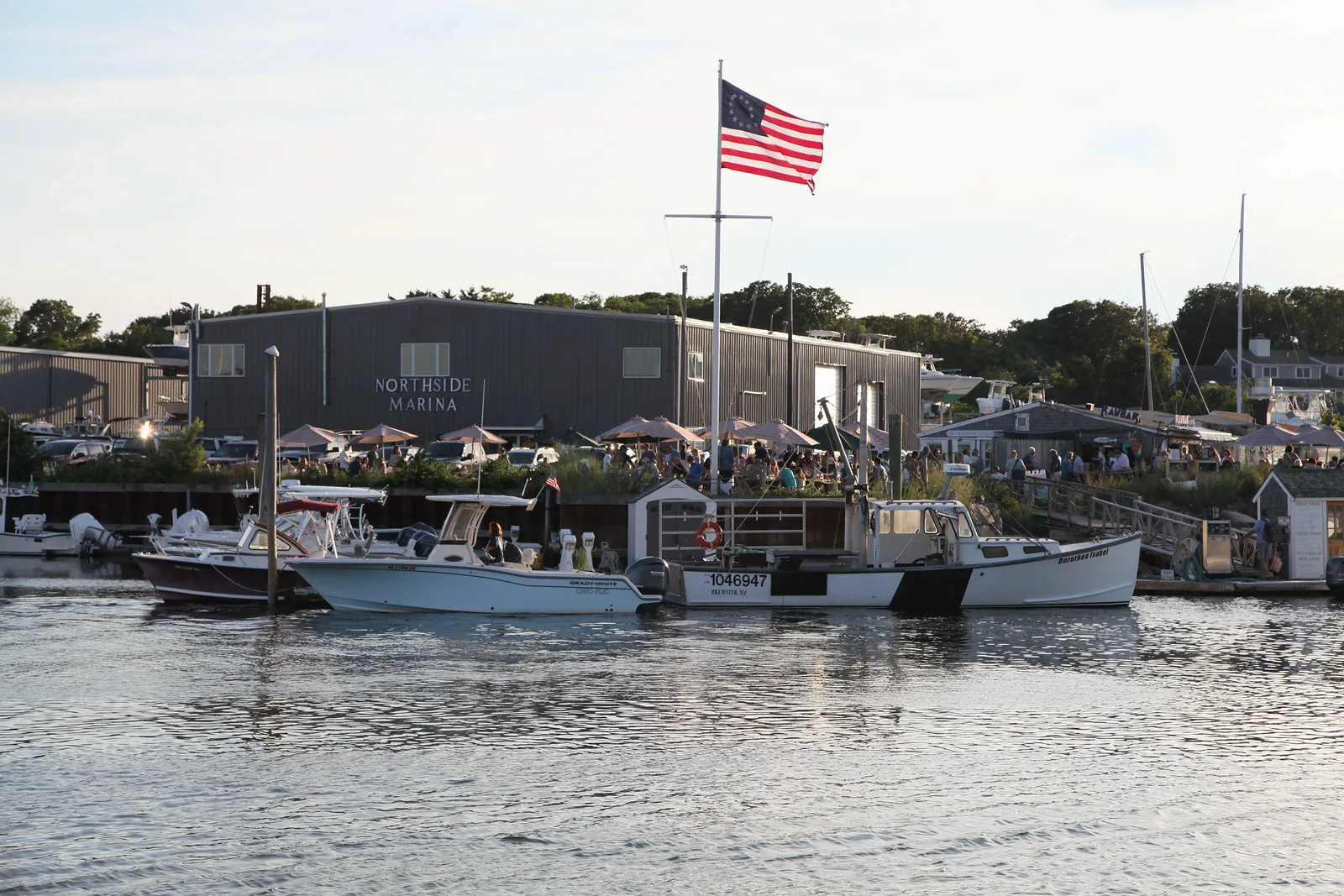 American flag over Northside Marina at Sesuit Harbor in East Dennis, Massachusetts.