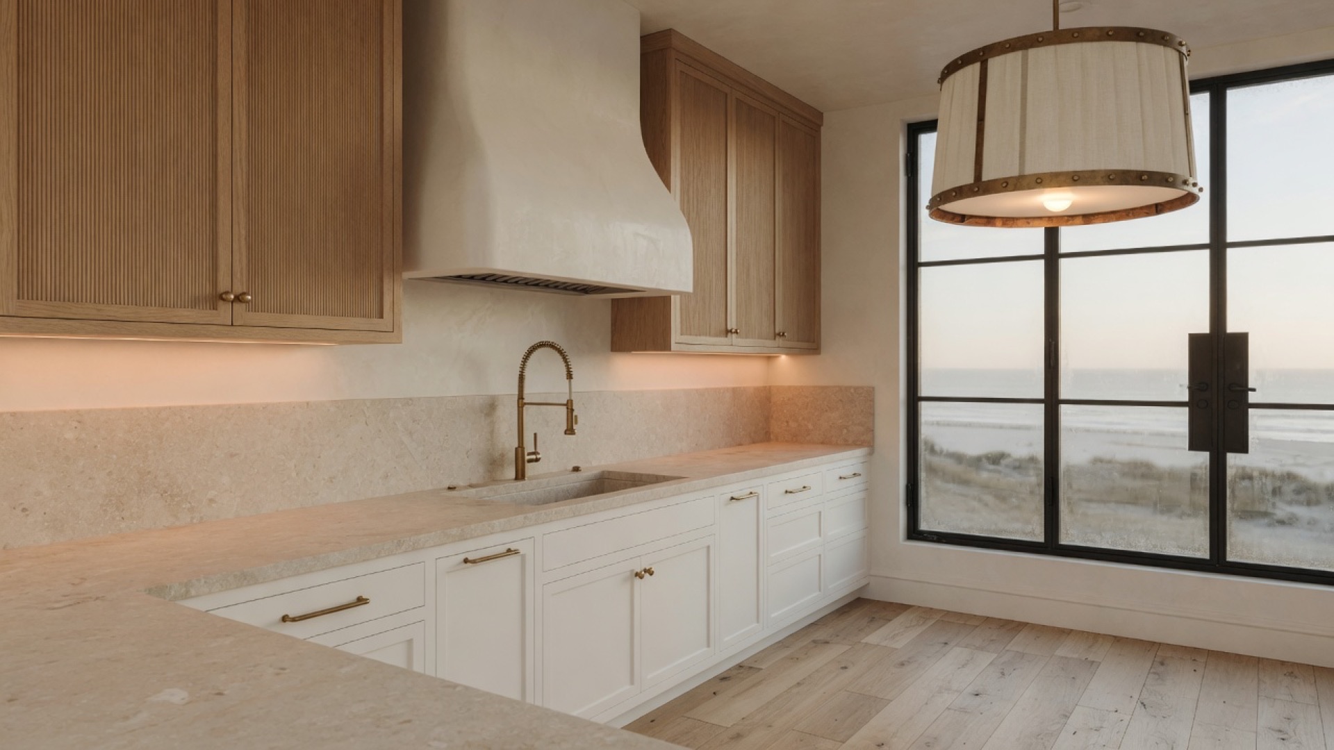Custom kitchen with island, stone counters, and panel-ready appliances in a coastal custom home