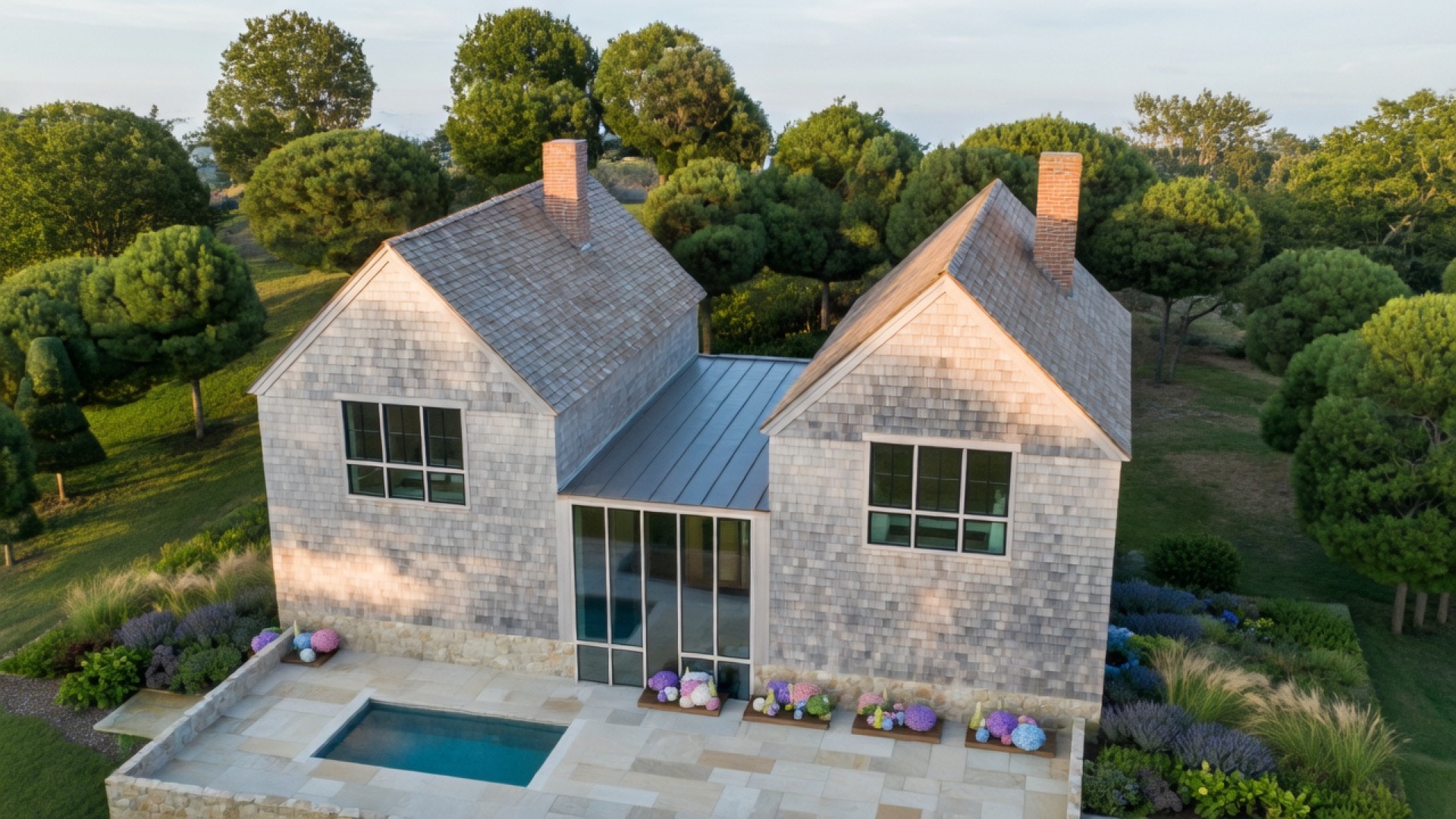 Water-side elevation of a coastal custom home with large glazing and cedar shingle